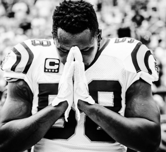 Carolina Panthers quarterback Cam Newton prays along the sideline